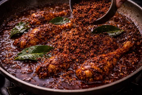 Kerisik dan daun limau purut dikisar halus dimasukkan ke rendang